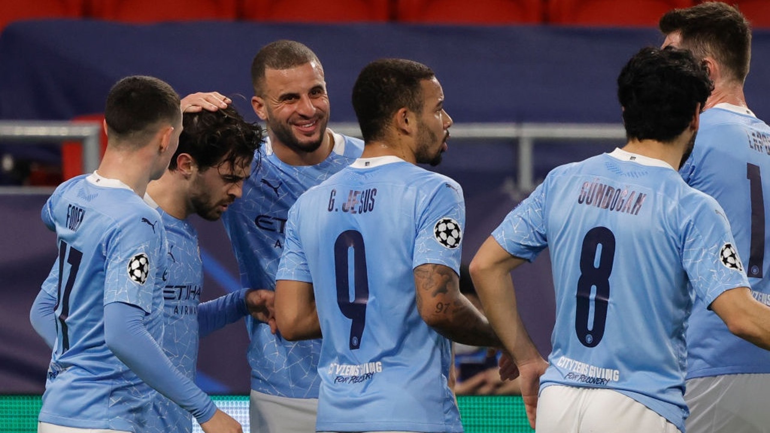 BER-NODDO: The players gather to congratulate Bernardo after his accurate headed goal.