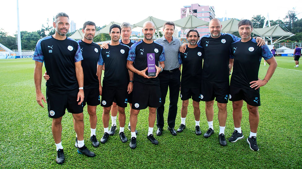 PRIZE GUYS : Pep Guardiola proudly holds aloft the 2019 manager of the year award along with members of the City coaching team