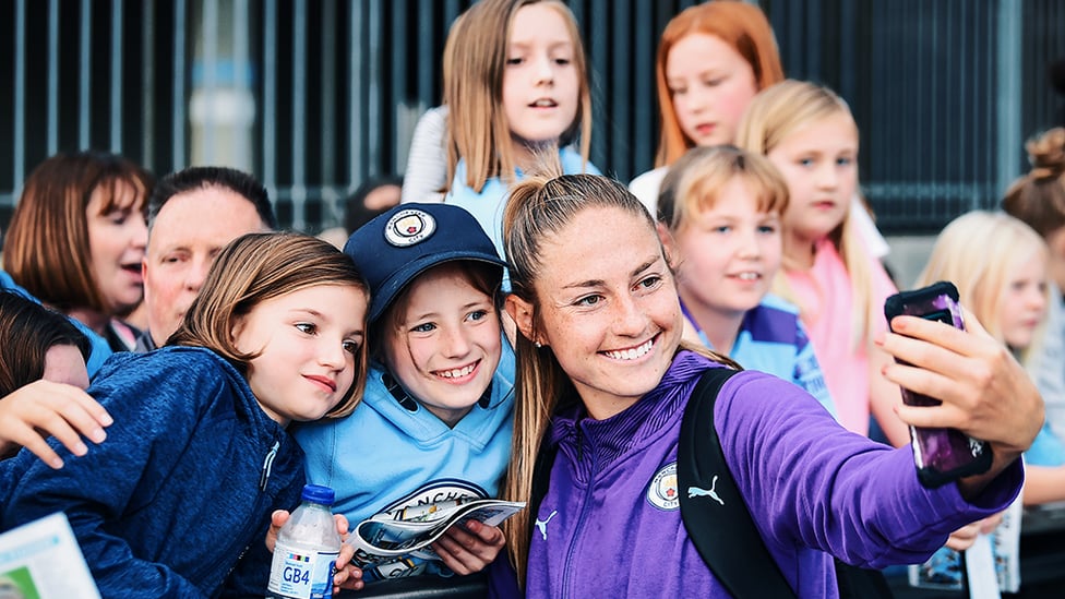 SMILES : Janine Beckie stops for the fans.