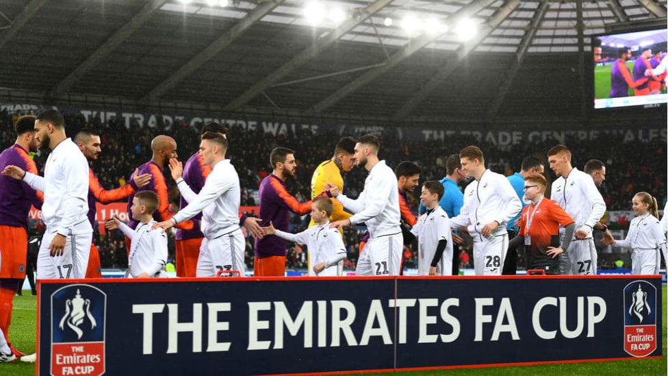 SHAKE ON IT : The players exchange greetings before kick-off