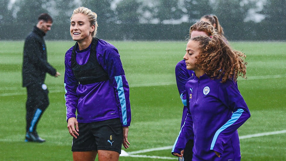 HAPPY FEET : Skipper Steph Houghton tries to keep warm while Matilde Fidalgo acclimatises to the Mancunian weather