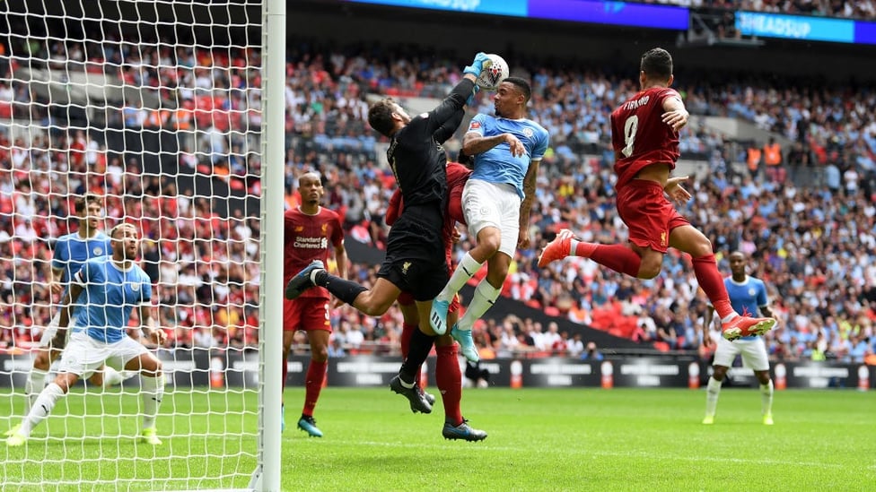 PRESSURE : Gabriel Jesus challenges compatriot Alisson Becker in the second half.