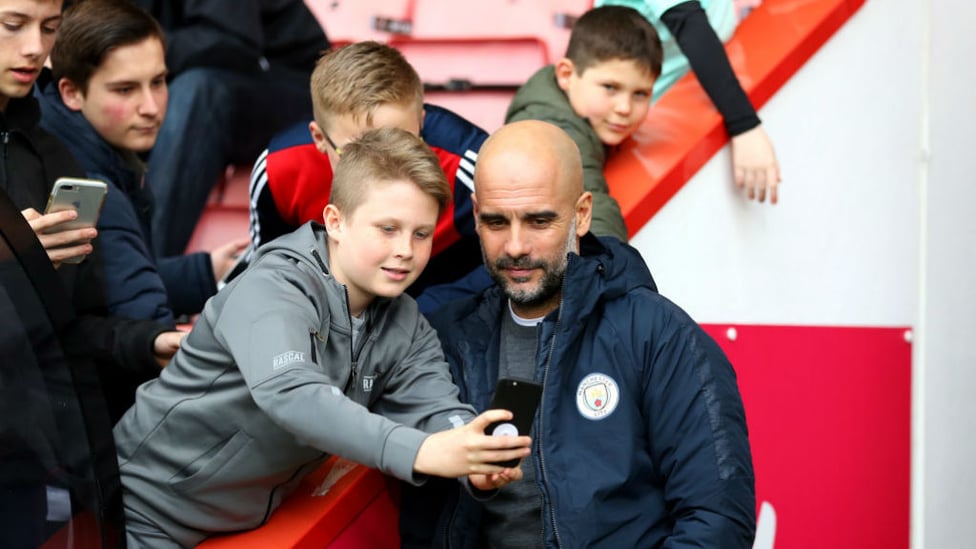 CENTRE OF ATTENTION : The boss poses for a picture with some happy young Bournemouth fans prior to kick-off