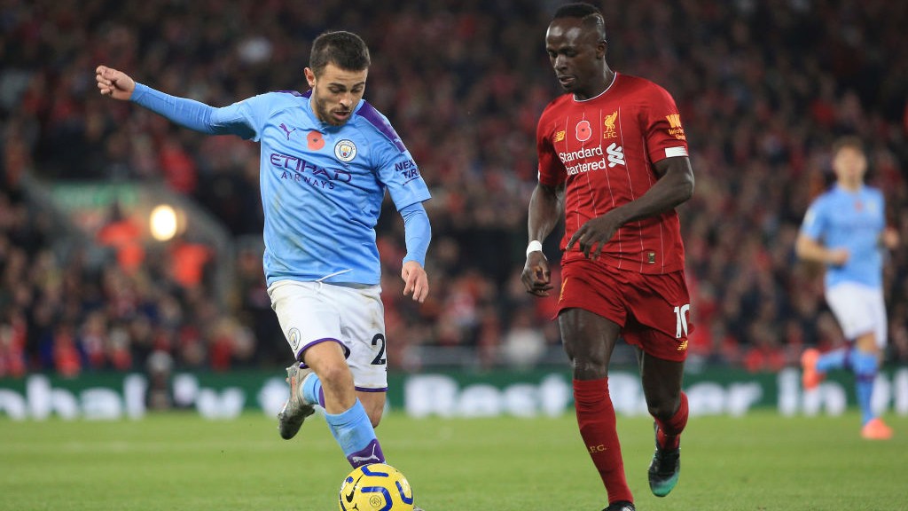 HEAD TO HEAD : Bernardo drives at the Reds' defence after Liverpool took an early lead through Fabinho.